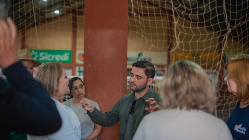 Foto mostra o vice-governador Gabriel Souza gesticulando enquanto conversa com membros da comunidade escolar de Independência, durante visita ao município.
